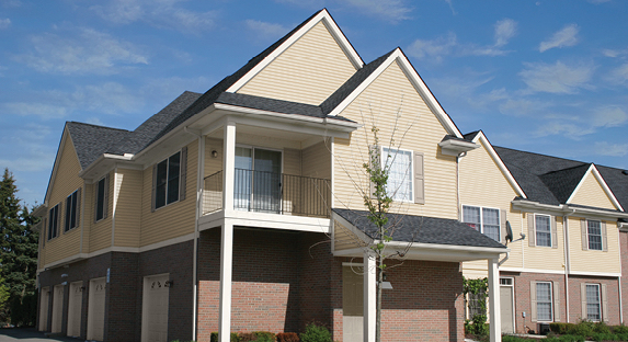 Townhomes with brick first floor exterior, Cream in My Coffee second floor, Swiss Coffee trim and Gallery Grey shutters.